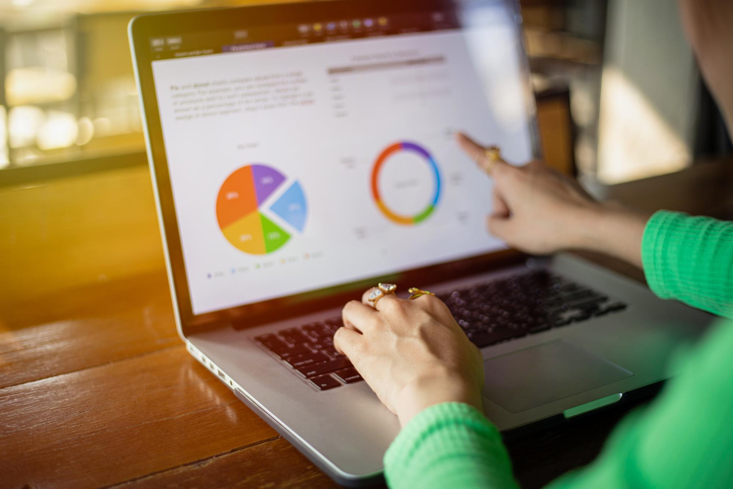 Woman reviewing unique visitor analytics with pie chart on laptop